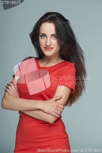 Image of Bright smiling business woman in red dress