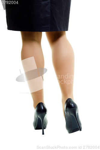Image of Female legs in skirt and high heels. isolated