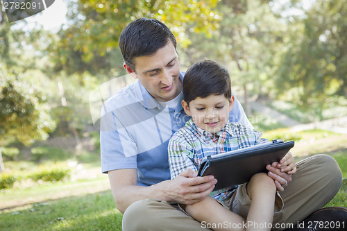 Image of Handsome Mixed Race Father and Son Playing on Computer Tablet