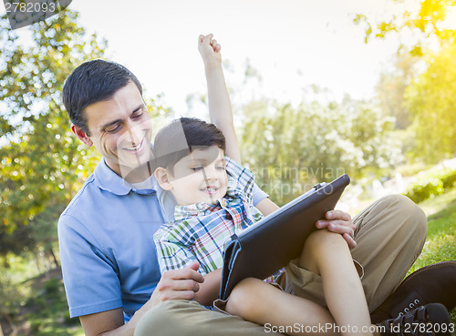 Image of Handsome Mixed Race Father and Son Playing on Computer Tablet