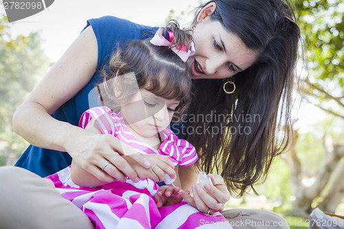 Image of Young Mother and Cute Baby Girl Applying Fingernail Polish