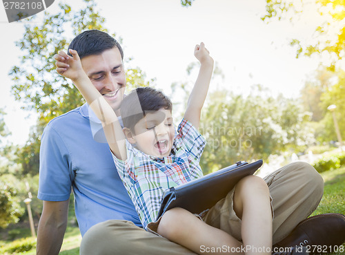 Image of Handsome Mixed Race Father and Son Playing on Computer Tablet