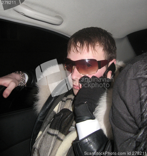 Image of The glamour extravagant guy with phone in car