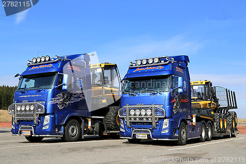 Image of Two Volvo FH13 Trucks Hauling Ponsse Forestry Machinery