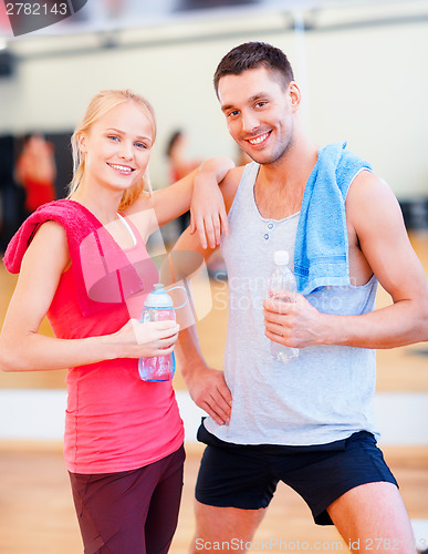 Image of two smiling people in the gym