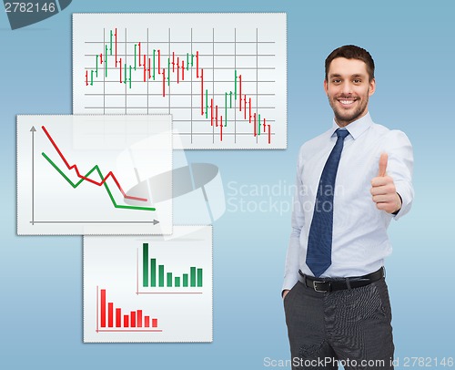 Image of handsome businessman showing thumbs up