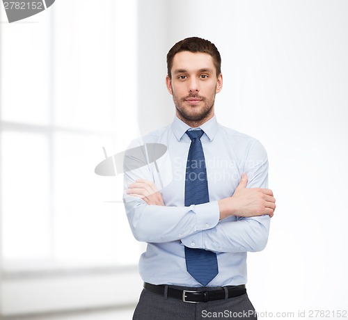 Image of handsome businessman with crossed arms