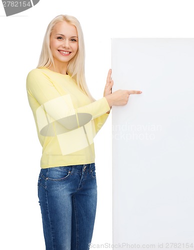 Image of smiling woman in sweater with blank white board