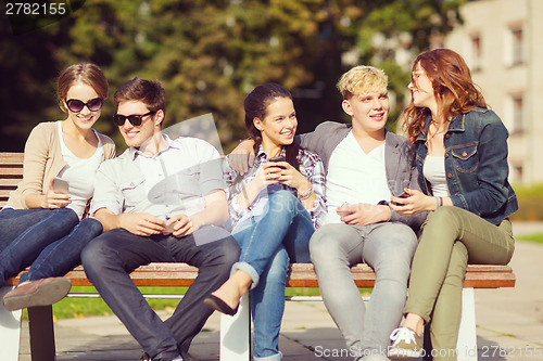 Image of students looking at smartphones and tablet pc