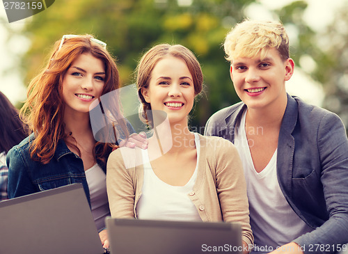 Image of students or teenagers with laptop computers