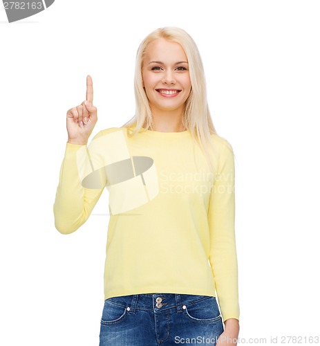 Image of smiling woman pointing her finger up