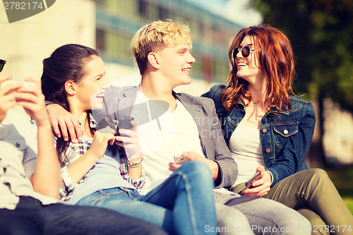 Image of students looking at smartphones and tablet pc