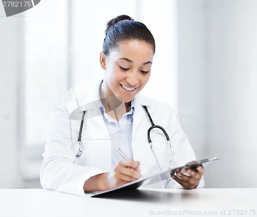 Image of female doctor writing prescription