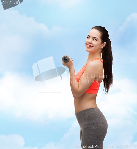 Image of young sporty woman with light dumbbells