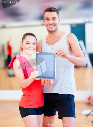 Image of two smiling people showing blank tablet pc screen
