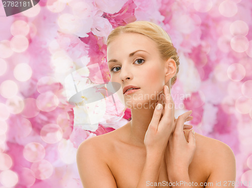 Image of beautiful woman touching her face skin