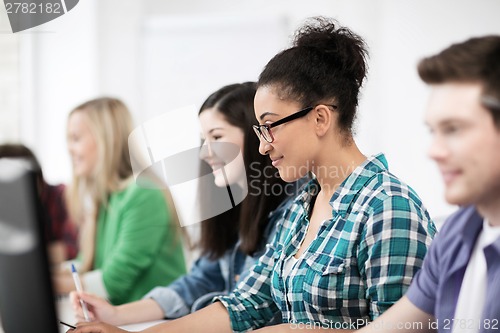 Image of african student with computer studying at school