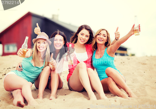 Image of girls with drinks on the beach