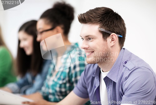 Image of student with computer studying at school