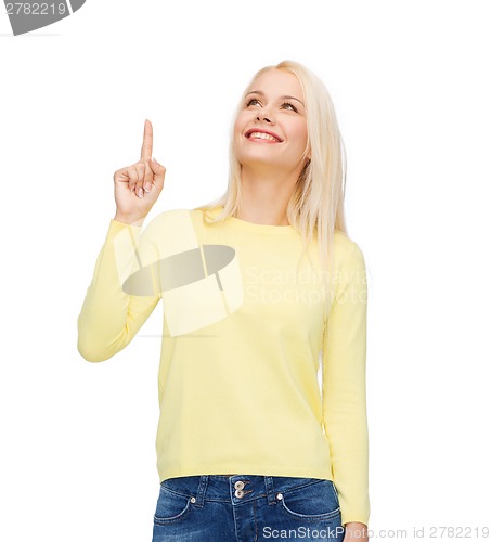 Image of smiling woman pointing her finger up