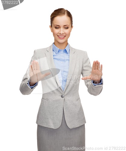 Image of smiling businesswoman pointing to something