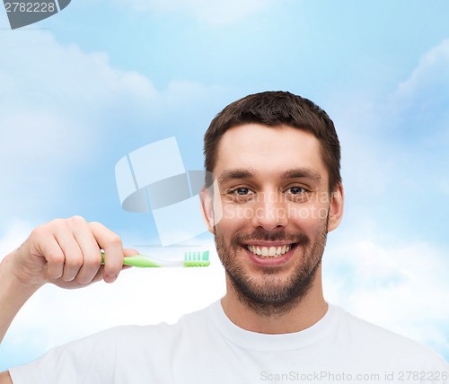 Image of smiling young man with toothbrush