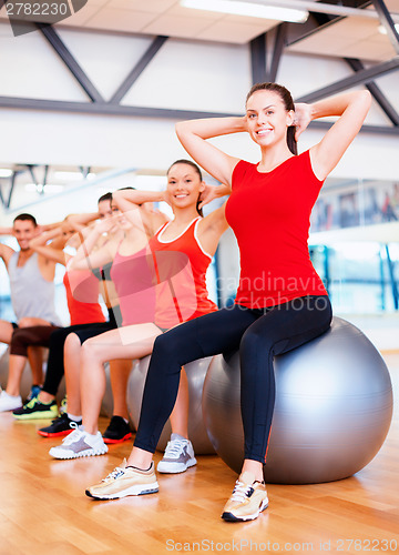 Image of group of people working out in pilates class