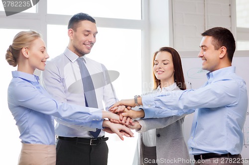 Image of business team celebrating victory in office