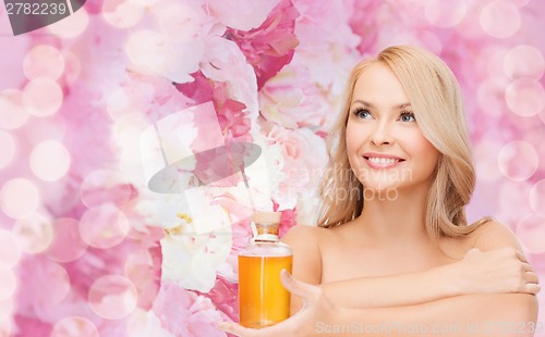 Image of happy woman with oil bottle