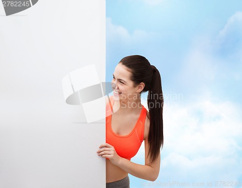 Image of teenage girl in sportswear with white board