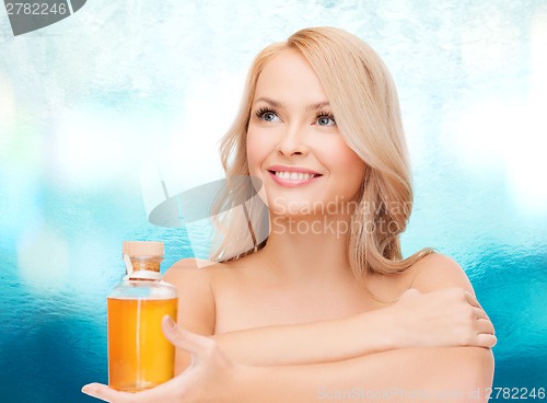 Image of happy woman with oil bottle