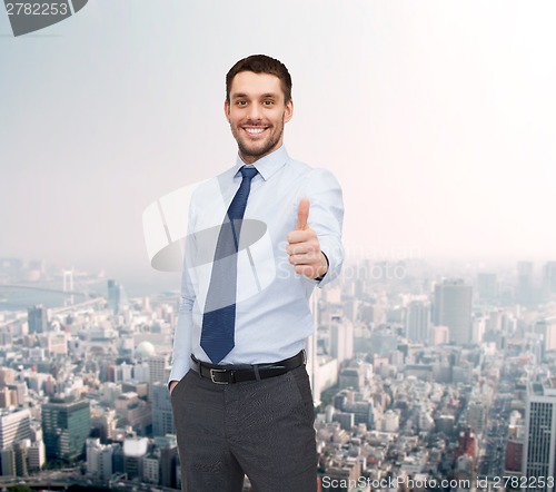 Image of handsome businessman showing thumbs up