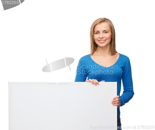 Image of smiling woman in sweater with blank white board