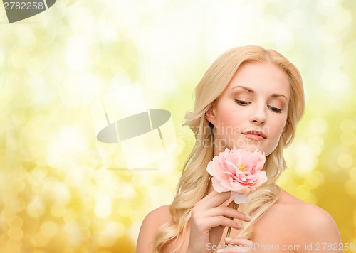 Image of lovely woman with peony flower