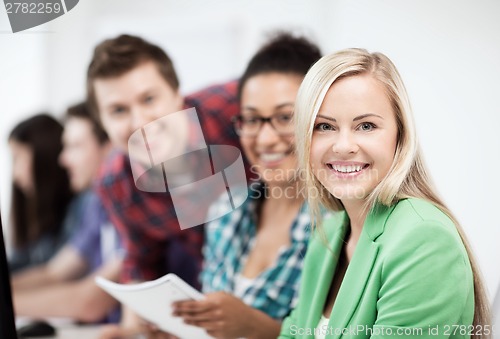 Image of students with computer studying at school