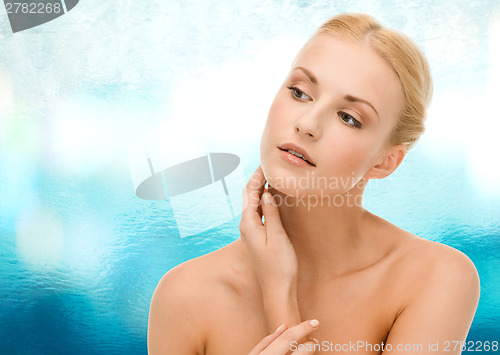 Image of beautiful woman touching her face skin