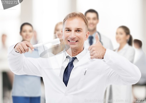 Image of dentist with toothbrush in hospital