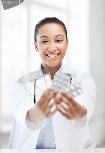 Image of doctor with blister packs of pills