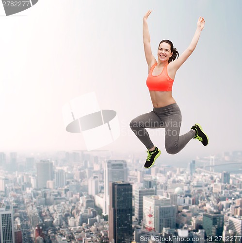 Image of sporty teenage girl jumping in sportswear