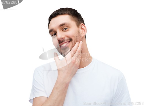 Image of beautiful smiling man touching his face