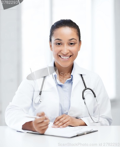 Image of female doctor writing prescription