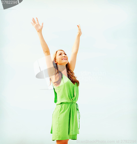 Image of girl with hands up in harbour