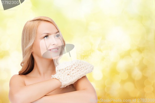 Image of smiling woman with exfoliation glove