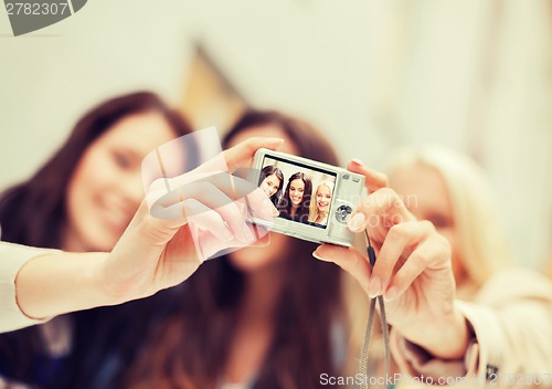 Image of beautiful girls taking picture in the city