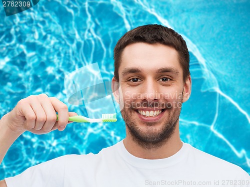 Image of smiling young man with toothbrush