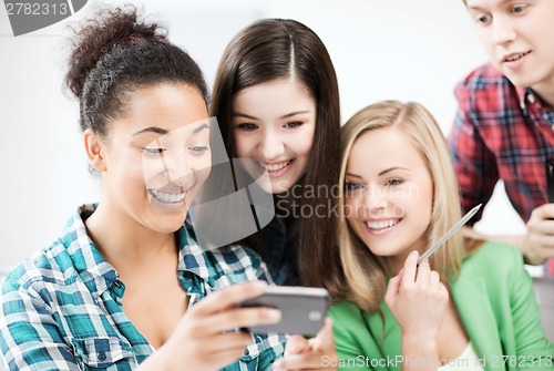 Image of students looking at smartphone at school