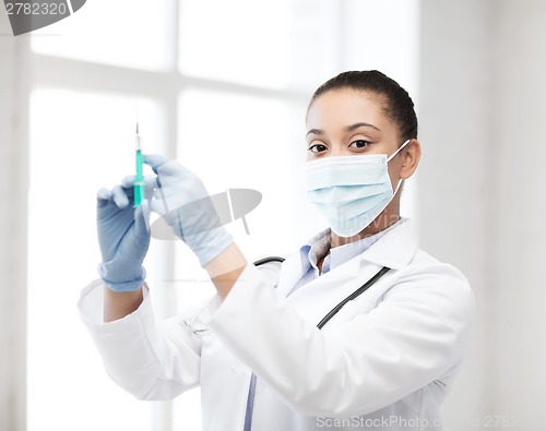 Image of african doctor holding syringe with injection