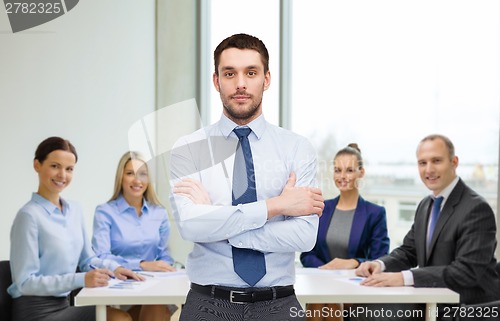 Image of handsome businessman with crossed arms