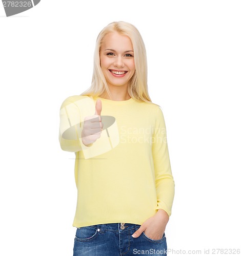 Image of smiling girl in casual clothes showing thumbs up