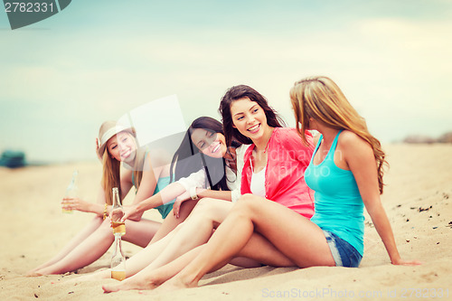 Image of girls with drinks on the beach